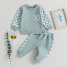 Stylish toddler boy wearing a cool boys checkered sweater terno set.