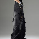 Young man wearing stylish black mens vintage distressed drawstring jeans.