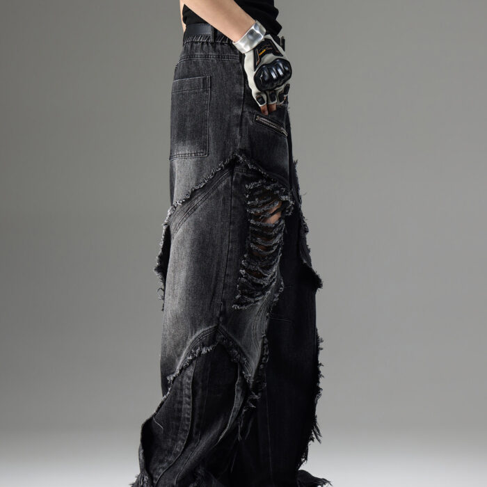 Young man wearing stylish black mens vintage distressed drawstring jeans.