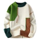 Handsome young man wearing a stylish mens colorblock pullover sweater.