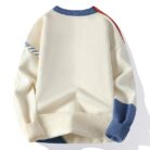 Handsome young man wearing a stylish mens colorblock pullover sweater.