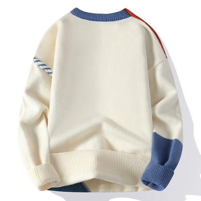 Handsome young man wearing a stylish mens colorblock pullover sweater.