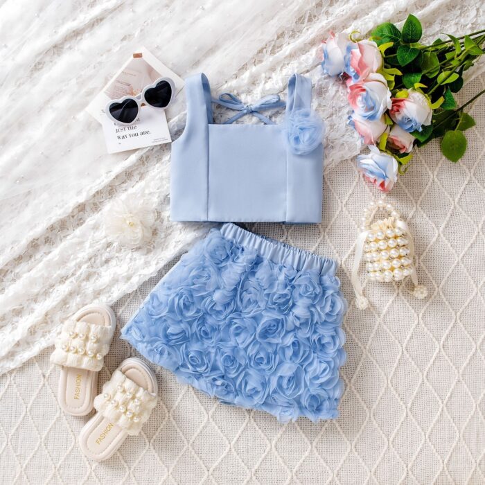 Cute little girl wearing a pink girls floral terno shorts with rose petal details.