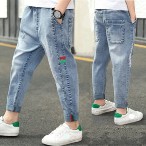 Close-up of the neat waistband and comfortable cotton fabric on kids casual denim pants.