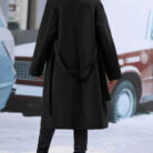 Close-up of the adjustable belt and classic lapel on a double breasted coat for women.