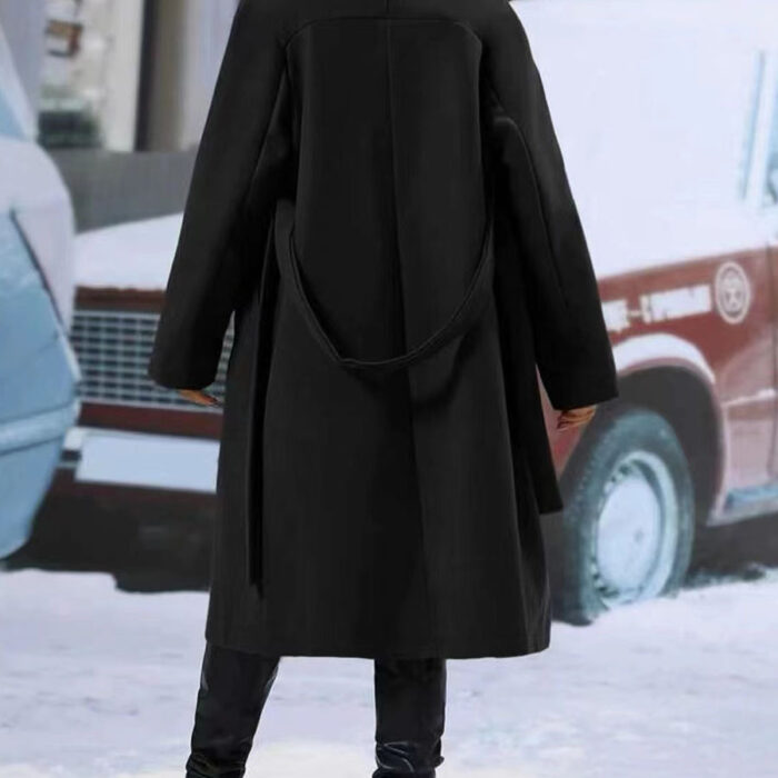 Close-up of the adjustable belt and classic lapel on a double breasted coat for women.
