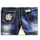Close-up of the neat waistband and comfortable cotton fabric on kids casual denim pants.