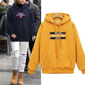 Stylish young woman wearing a trendy womens oversized letter print hoodie for everyday casual wear.