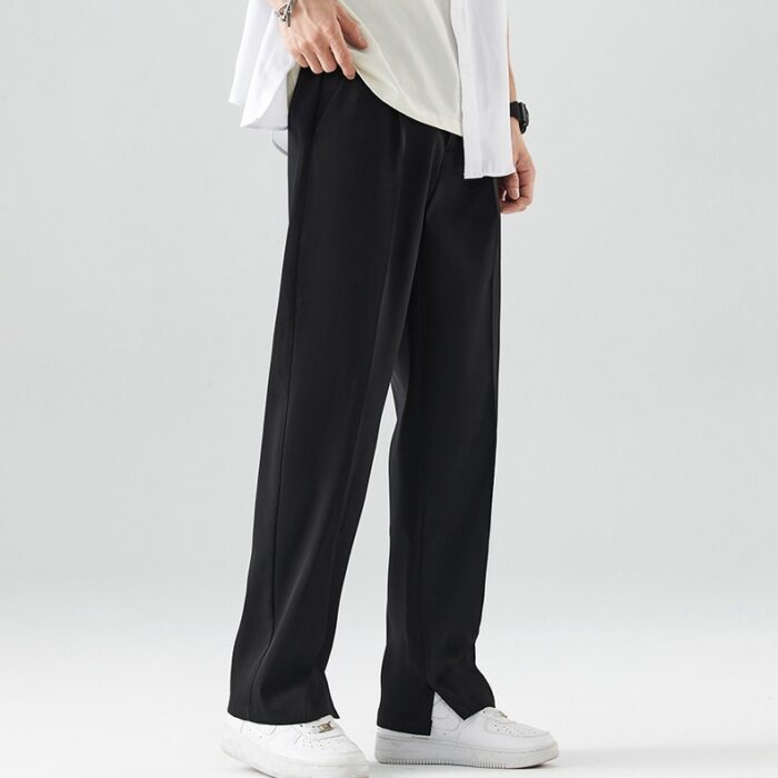 106fe6e7-b4be-4b37-ad80-103eee30e81c.jpg A stylish man wearing comfortable mens casual suit pants for a smart casual office look.