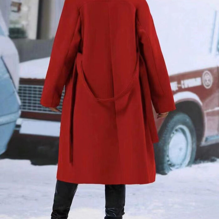 Close-up of the adjustable belt and classic lapel on a double breasted coat for women.