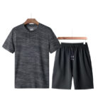 Athletic man working out wearing a breathable mens sports terno set.