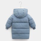 A happy child staying warm in the snow wearing a stylish kids thick winter coat.