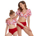 Beautiful mom and her little girl at the beach wearing a mommy and me twinning swimsuit.