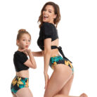 Beautiful mom and her little girl at the beach wearing a mommy and me twinning swimsuit.