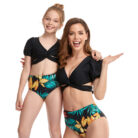 Beautiful mom and her little girl at the beach wearing a mommy and me twinning swimsuit.