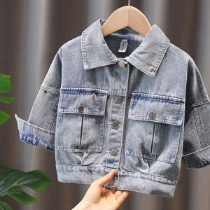 A stylish little girl wearing a versatile girls denim jacket for a cute everyday look.