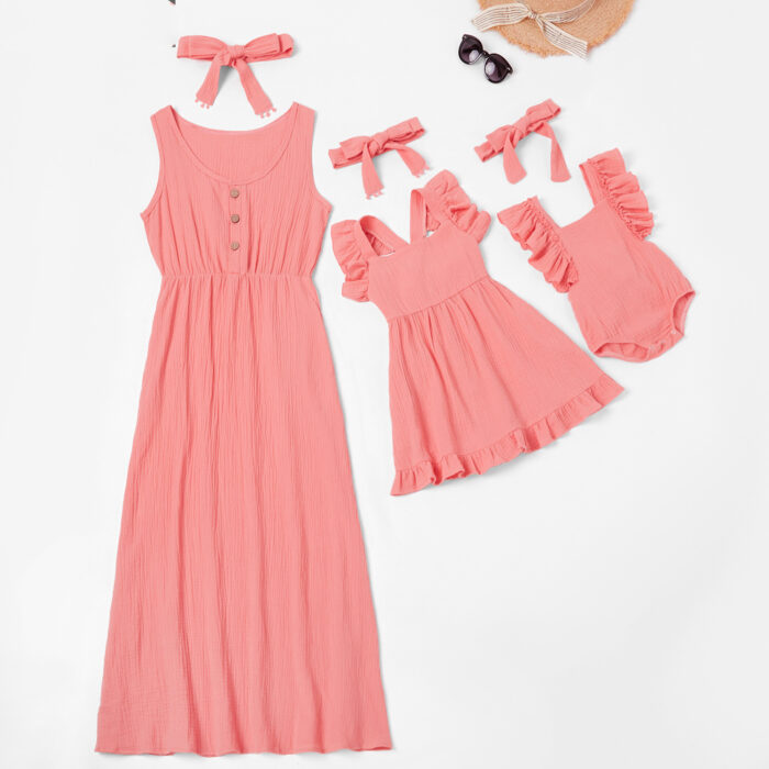 Beautiful mom and her little girl wearing a matching mother and daughter twinning dress.