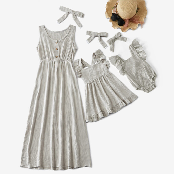 Beautiful mom and her little girl wearing a matching mother and daughter twinning dress.
