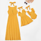 Beautiful mom and her little girl wearing a matching mother and daughter twinning dress.