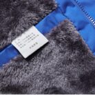 Close-up of the thick faux fur collar and weather-resistant shell on a mens fleece lined winter jacket.