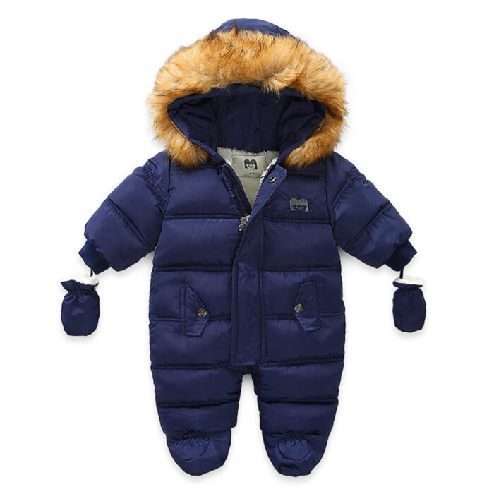 An adorable baby staying warm in a thick baby winter snowsuit with mittens.