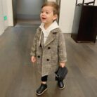 A cute toddler wearing a stylish toddler fall and winter coat for cold weather.