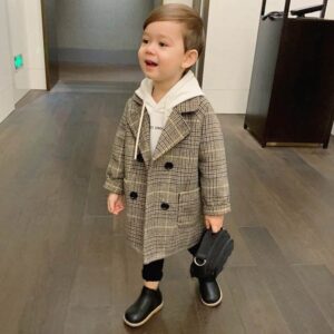 A cute toddler wearing a stylish toddler fall and winter coat for cold weather.