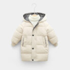 A happy child staying warm in the snow wearing a stylish kids thick winter coat.