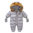 An adorable baby staying warm in a thick baby winter snowsuit with mittens.