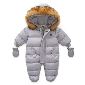 An adorable baby staying warm in a thick baby winter snowsuit with mittens.