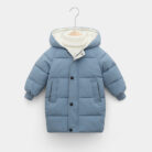 A happy child staying warm in the snow wearing a stylish kids thick winter coat.