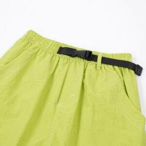 Close-up of the water-repellent nylon fabric and elastic drawstring on waterproof outdoor pants for kids.