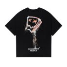 A stylish man wearing a trendy mens oversized graphic t shirt with a paint splatter design.
