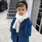 A cute toddler wearing a stylish toddler fall and winter coat for cold weather.