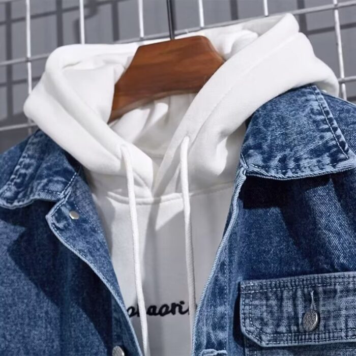 A stylish man wearing a versatile mens hooded denim jacket for a casual layered streetwear look.