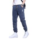 Stylish young man wearing comfortable mens denim jogger pants.