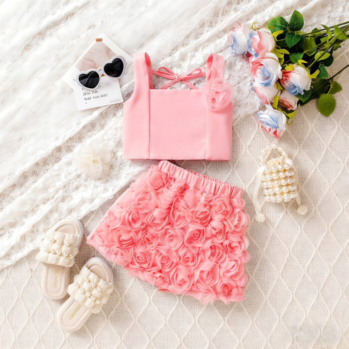 Cute little girl wearing a pink girls floral terno shorts with rose petal details.