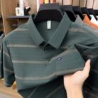A stylish man wearing a comfortable mens striped polo shirt for a smart casual weekend look.