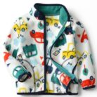 A happy child wearing a comfortable kids lightweight zip up jacket ready for outdoor play.