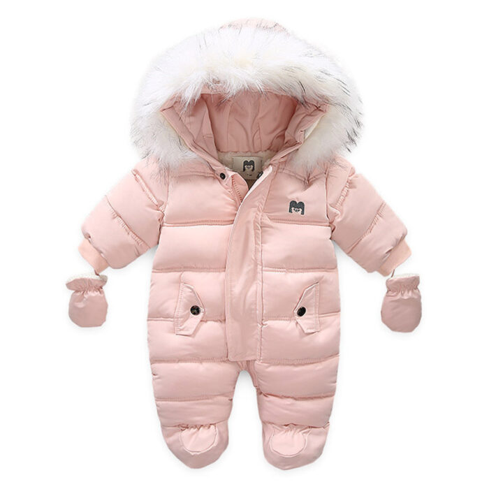 An adorable baby staying warm in a thick baby winter snowsuit with mittens.