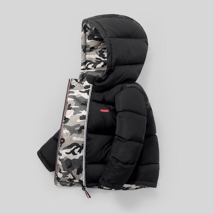 Close-up of the thick thermal cotton insulation and smooth zipper on a kids padded winter jacket.