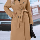 Close-up of the adjustable belt and classic lapel on a double breasted coat for women.