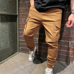 Stylish young man wearing trendy mens casual cargo pants with utility pockets.