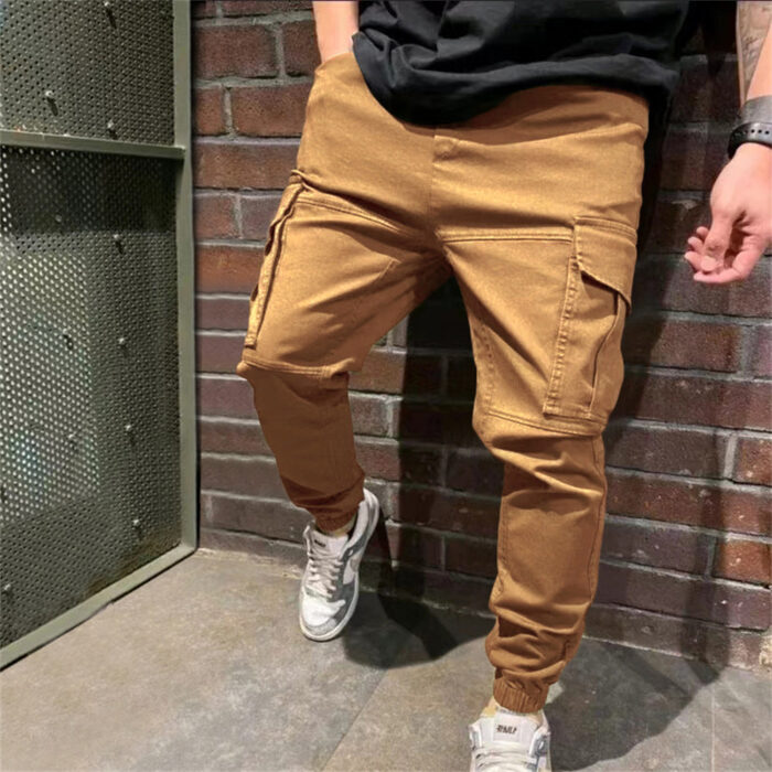 Stylish young man wearing trendy mens casual cargo pants with utility pockets.