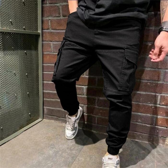 Stylish young man wearing trendy mens casual cargo pants with utility pockets.