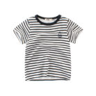 A cute child wearing a comfortable kids striped cotton t shirt for everyday summer play.