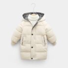 A happy child staying warm in the snow wearing a stylish kids thick winter coat.