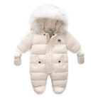 An adorable baby staying warm in a thick baby winter snowsuit with mittens.
