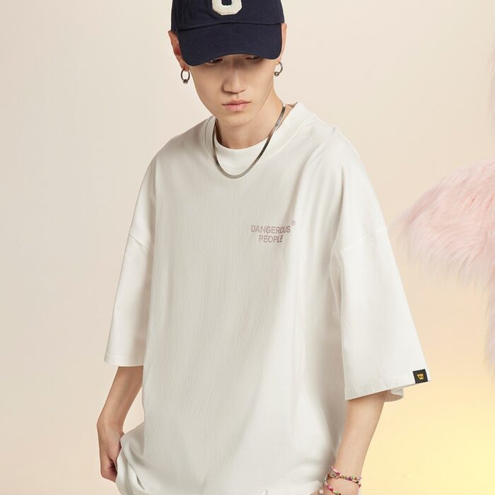 567c3d67-b232-4826-b9b7-d70342be9bd0.jpg A stylish man wearing a trendy mens oversized graphic t shirt with a paint splatter design.