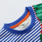 A happy little boy wearing a comfortable boys cotton dinosaur t shirt for everyday summer play.